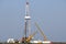 Land oil drilling rig and cranes on oilfield