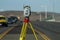 Land survey equipment set up on road with road becoming a hill