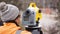 Land surveyor operating a digital precision measurement level