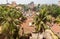 Landcape of indian city with palm trees and red tiles roof and tall buildings