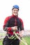 Landed parachutist in red uniform smiles in camera