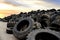 Landfill with old tires and tyres for recycling. Reuse of the waste rubber tyres. Disposal of waste tires. Worn out wheels for