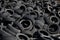 Landfill with old tires and tyres for recycling. Reuse of the waste rubber tyres. Disposal of waste tires. Worn out wheels for