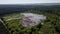 Landfill removal of unsorted debris in the middle of the forest. Aerial photography with drone