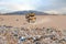 Landfill and tractor in desert