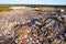 Landfill waste disposal. Garbage dump with waste plastic and polyethylene. Bulldozer at landfill working on rubbish disposal.