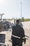 Landfill worker directing skid steer loader on the waste heap