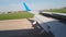 Landing aircraft view through the porthole of the aircraft. Aircraft flaps open for landing braking