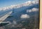 Landing in the city of Vancouver. Aerial view.  Buildings, houses, river. Sunny day and cloudy sky.