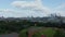 Landing footage in Battersea Park. Aerial with of modern sport areas. Cityscape with skyscrapers in background. Tilt