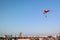 Landing of a fun parachuting activity against a clear blue sky at Dubai Marina