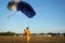 Landing of a parachuter against the background of forests and bu