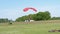 Landing Parachutist on Green Grass. Zoom. Slow motion