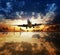 Landing plane flying over water surface reflecting sky