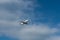 Landing plane in good weather against a blue sky