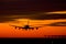 Landing plane on a sunset