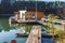 Landing stage house on wooden pier in water in forest in evening