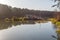 Landing stage house on wooden pier in water in forest in evening