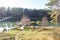 Landing stage house on wooden pier in water in forest in evening