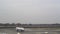 Landing and take-off of an airplane at an international airport in cloudy weather.