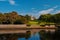 Landmark and attraction. Lews Castle in Stornoway, United Kingdom seen from sea harbor. Castle with green grounds on