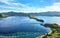 Landmark view of `Gili Lawa` with green savanna grass and blue sea in an evening, Komodo Island Komodo National Park, Labuan Baj