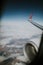 Lands and meadows of Spain, with blue sky on top and white clouds, viewed from a Norwegian Airlines plane