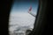 Lands and meadows of Spain, with blue sky on top and white clouds, viewed from a Norwegian Airlines plane