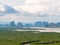 Landscape abundant nature tropical mangrove forest intertidal forest around limestone karst mountain sea blue sky white cloud.