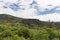 Landscape of Aderdare mountain. A blue sky and clouds over bright green jungle. Kenya