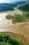 Landscape aerial top panoramic  view reservoir dam river and mountain green natural forest in the rain season