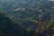 Landscape aerial view of beautiful terrace type crop field with few houses on mountain