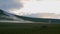 Landscape of alpine meadows in the evening. horses grazing in the field