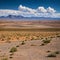 The landscape of Alvord Desert, Oregon has a dried lake bed and desert terrain w...