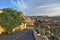 The landscape of amazing Cappadocia. The asphalt highway, enclosed by a grate, descends from the mountain