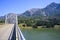 Landscape with arched truss bridge over the Columbia River with high rocky mountains in Columbia Gorge