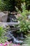 Landscape architecture featuring waterfalls and perennials for backyard oasis