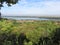 Landscape area seen from the hill sunny flat land, village and river