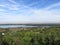 Landscape area seen from the hill sunny flat land, village and river