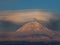 Landscape with the Arenal volcano which hangs over the lenticular cloud. Lenticular clouds above Kamchatka volcanoes at sunset