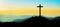 Landscape background banner panorama -.Breathtaking view with black silhouette of mountains, hills, forest and cross / summit