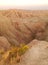 The landscape of the Badlands shows bands of color in the dry eroded soil