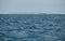 The landscape of the balearic sea, azure water, sunny weather, is a lonely sail boat is on the horizon