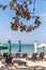 Landscape of balinese public beach with umbrellas and deck chairs. Bali island.