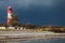 Landscape baltic sea dunes lighthouse in red and white