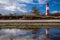 Landscape baltic sea dunes lighthouse in red and white