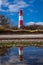 Landscape baltic sea dunes lighthouse in red and white