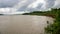 The landscape of Bangladesh next to a beautiful river. Cloudy skies in the midday sun. It is the river Gorai Madhumati