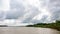 The landscape of Bangladesh next to a beautiful river. Cloudy skies in the midday sun. It is the river Gorai Madhumati