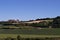 Landscape in Bavaria with green fields and meadows against a blue sky. Harburg Castle stands in the sun on a gentle hill